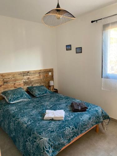 a bedroom with a bed with two towels on it at Brindingaccia in Propriano