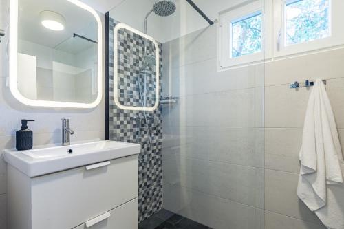 a white bathroom with a sink and a shower at Villa Pinus in Stari Grad