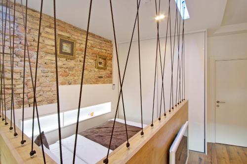 a staircase in a room with a brick wall at Angel Wing Apartamentai in Vilnius