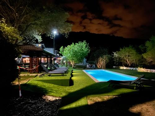 a backyard at night with a swimming pool at Gec in Zaprešić