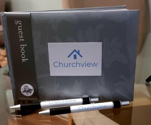 a pen sitting next to a box on a table at Churchview in Townhill