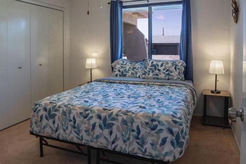 a bedroom with a large bed with a window at Cheerful Pool Home-Lowkey, 10min to Lake, Comfort in Lake Havasu City
