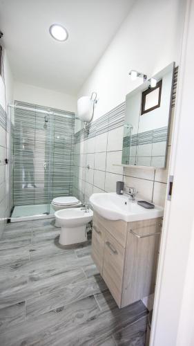a bathroom with a sink and a toilet and a shower at Palazzo d'Aquino in Boscoreale
