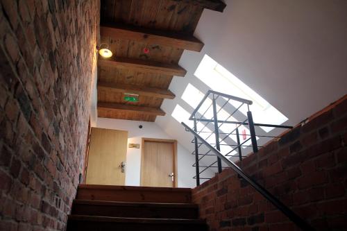 a stairway with a brick wall and a skylight at Noclegi Złota Podkowa in Olszowa