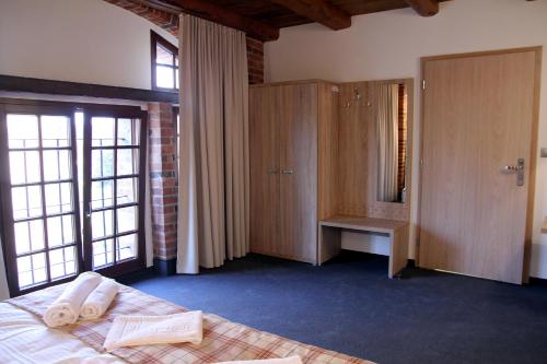 a bedroom with a bed with towels on it at Noclegi Złota Podkowa in Olszowa