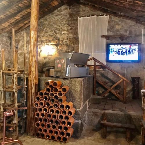 a room with a television and a pile of pipes at Quinta dos Carvalhos The Wine House Farm in Center of Lamego - Capital of the Douro in Lamego