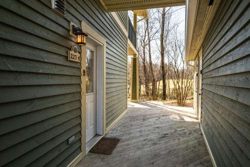a door to a house with a sign on it at Le Serein Condo Tremblant Les-Eaux in Mont-Tremblant