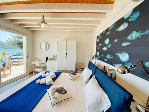 a bedroom with a blue and white bed in a room at Il Profumo del Mare in Cagliari