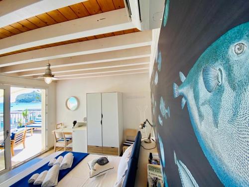 a bedroom with a large mural of a fish on the wall at Il Profumo del Mare in Cagliari