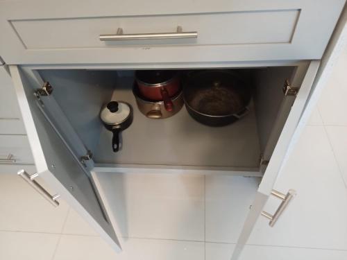 a drawer in a kitchen with some pots and pans at Luxury 2 Bedroom Rooftop pool View unit #3 in Falmouth
