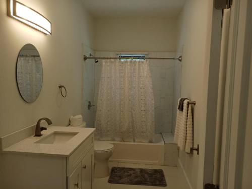 a bathroom with a sink and a toilet and a shower at Luxury 2 Bedroom Rooftop pool View unit #3 in Falmouth