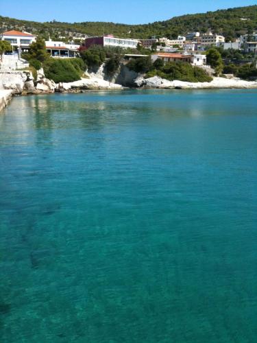 a large body of blue water with buildings in the background at Anatoli Hotel in Agia Marina Aegina