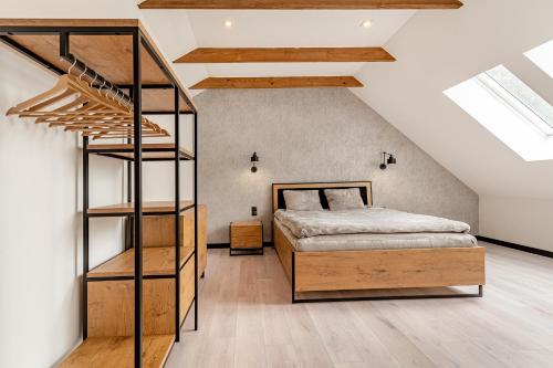 a loft bedroom with a bunk bed and a ladder at Villa Warminska in Kręsk