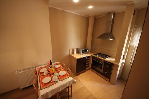 a small kitchen with a table with food on it at Luksusowy Apartament III in Sopot