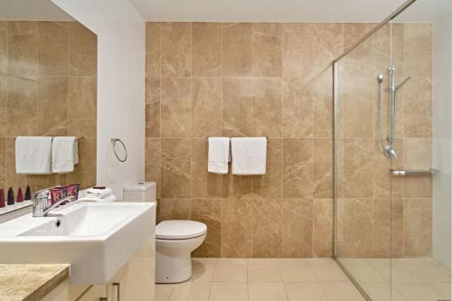 y baño con ducha, lavabo y aseo. en Large Premium Warrawee Apartment with Parking A401 en Warrawee