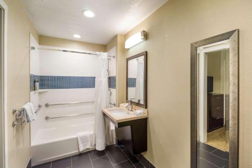 a bathroom with a tub and a sink and a shower at Sonesta ES Suites Torrance Redondo Beach in Torrance