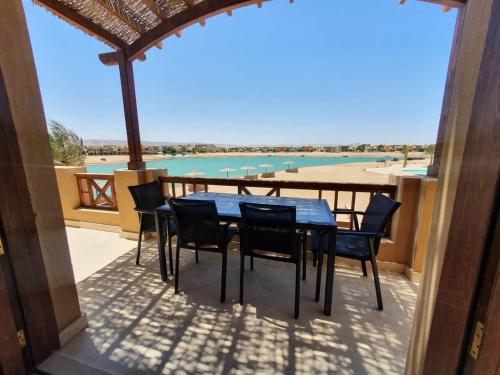 a table and chairs on a patio with a view of the water at Sabina 2br penthouse in Hurghada