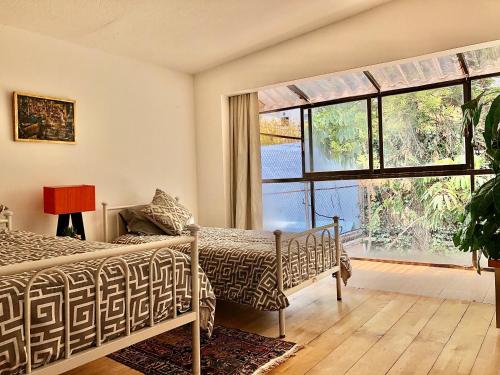 1 dormitorio con cama y ventana grande en Amplio 250m2, iluminado y céntrico en Palmas-Lomas, en Ciudad de México