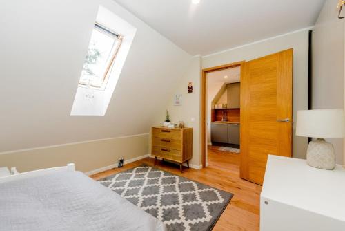 a bedroom with a bed and a window and a door at Karjamaa Apartment - Garden, Free parking, Air conditioning in Pärnu