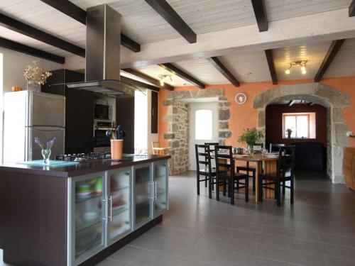 une cuisine et une salle à manger avec une table et des chaises dans l'établissement Charmant gîte rénové, 3 chambres, cheminée, terrasse et jardin, proche Brioude et sites touristiques. - FR-1-582-231, à Saint-Just-près-Brioude