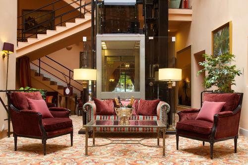 a lobby with two chairs and a coffee table at NARUTIS hotel in Vilnius