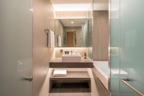 a bathroom with a sink and a mirror at Hotel Foret The Spa in Busan