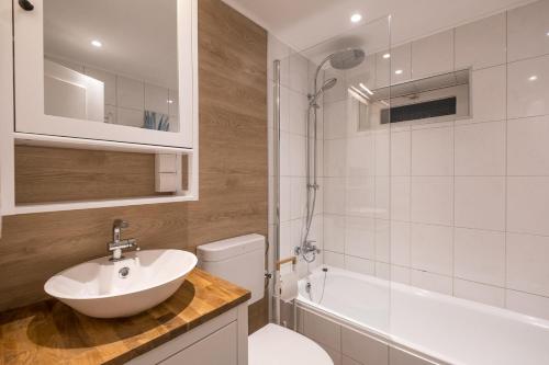 a bathroom with a sink and a toilet and a shower at Panoramic App C03-4 Sonnendeck in Sierksdorf