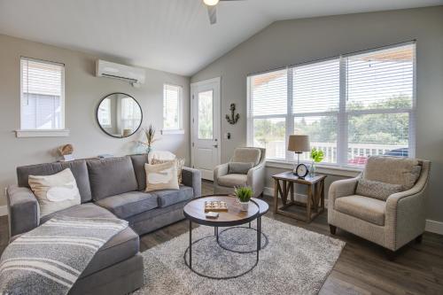 a living room with a couch and two chairs and a table at Tranquility Base Cottage in Ocean Shores