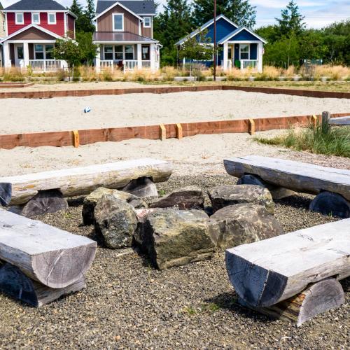 a group of benches and rocks in front of houses at Tranquility Base Cottage in Ocean Shores