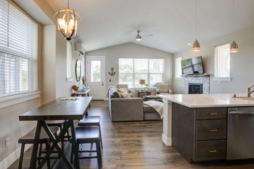a kitchen and living room with a table and chairs at Tranquility Base Cottage in Ocean Shores