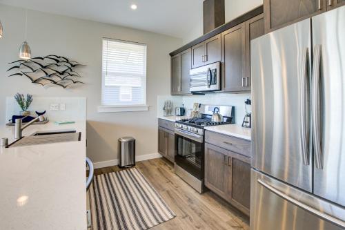 a kitchen with wooden cabinets and a stainless steel refrigerator at Tranquility Base Cottage in Ocean Shores