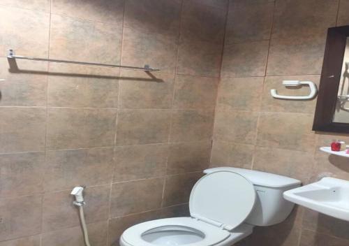 a bathroom with a toilet and a sink at Golden Bee PhiPhi in Phi Phi Don
