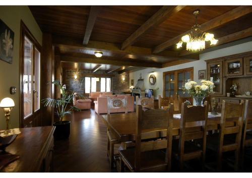 a dining room with a large wooden table and chairs at Hotel Rural El Portón de Murillo in Broto