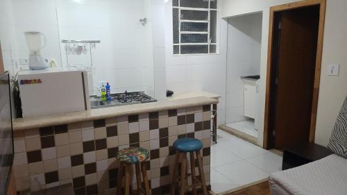 uma cozinha com um balcão com um lavatório e um fogão em Apartamento Tubal em Uberlândia