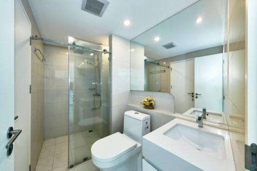 a bathroom with a toilet and a sink and a shower at City Center Residence by Tech in Pattaya Central