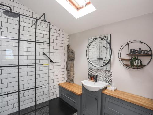 a bathroom with a sink and a shower at Cosy Cottage in Menai Bridge