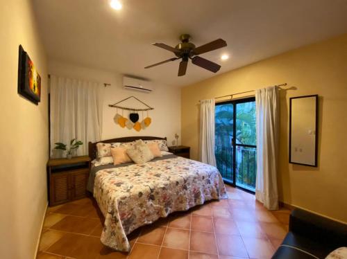 a bedroom with a bed and a ceiling fan at Apartment w/ PRIME location Mexican Colonial style in Playa del Carmen