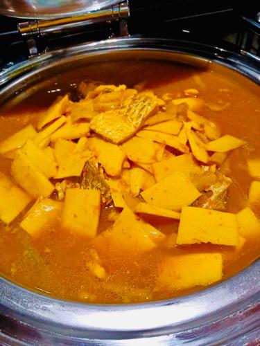 a pot of soup with meat and potatoes in it at Montana Hotel Songkhla in Songkhla