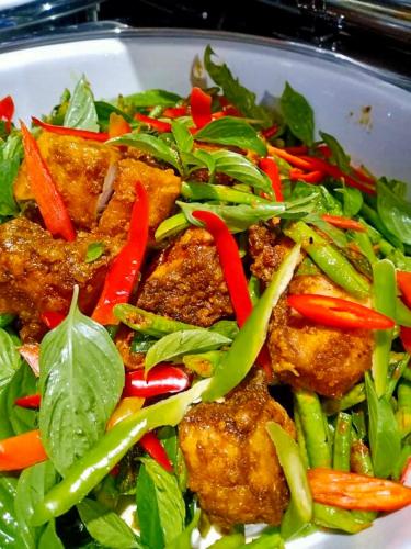 a salad with meat and vegetables in a white bowl at Montana Hotel Songkhla in Songkhla