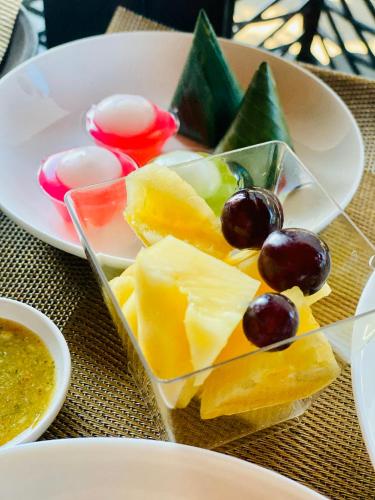 a plate of cheese and fruit on a table at Montana Hotel Songkhla in Songkhla