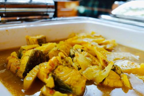 a styrofoam container of food with potatoes and squash at Montana Hotel Songkhla in Songkhla