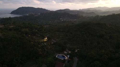 an aerial view of a valley with mountains and forests at Cersen Resort Lombok in Kuta Lombok