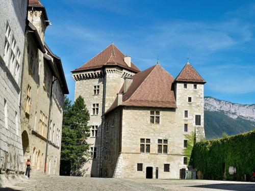 a large castle with two towers on a street at Aparthotel Adagio Annecy Centre in Annecy