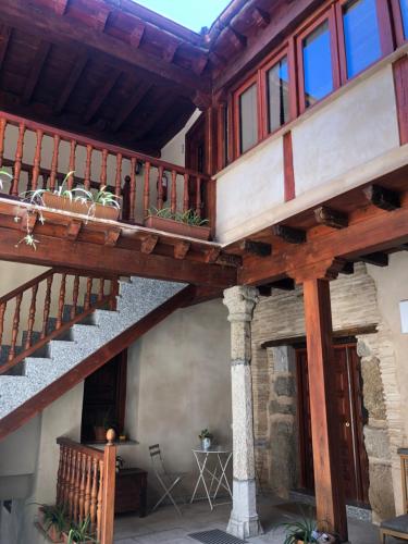 a wooden staircase in a house with a balcony at Apartamento Canónigo - terraza con vistas in Toledo