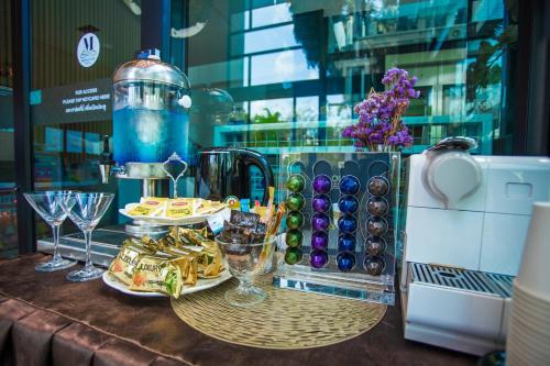 a table with wine glasses and food on it at Montana Hotel Songkhla in Songkhla