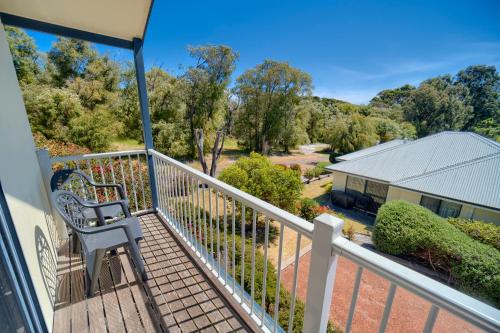a view from the balcony of a house with a bench at Bayside Villas in Walpole