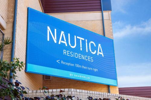 a blue sign on the side of a building at Nautica Residences Hillarys in Perth