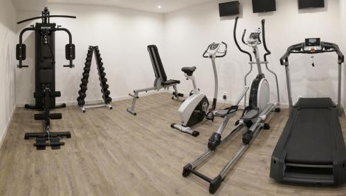 a gym with several exercise bikes in a room at Hotel Kapitol in Most