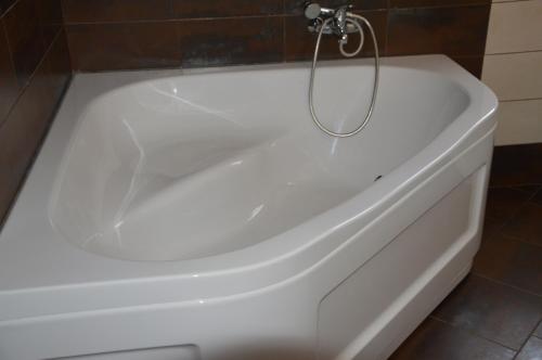 a white bath tub in a bathroom at Casa Lucia in Koper