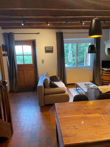 a living room with a couch and a table at Les Gîtes de l'aiguete in Hauterives